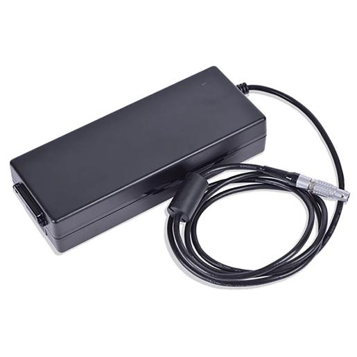 Black rectangular AC power brick with attached cable ending in a round push-pull connector